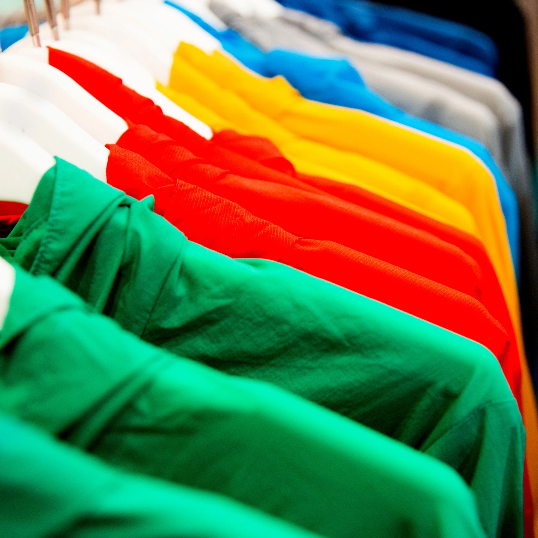 Colorful sportswear on hangers in store